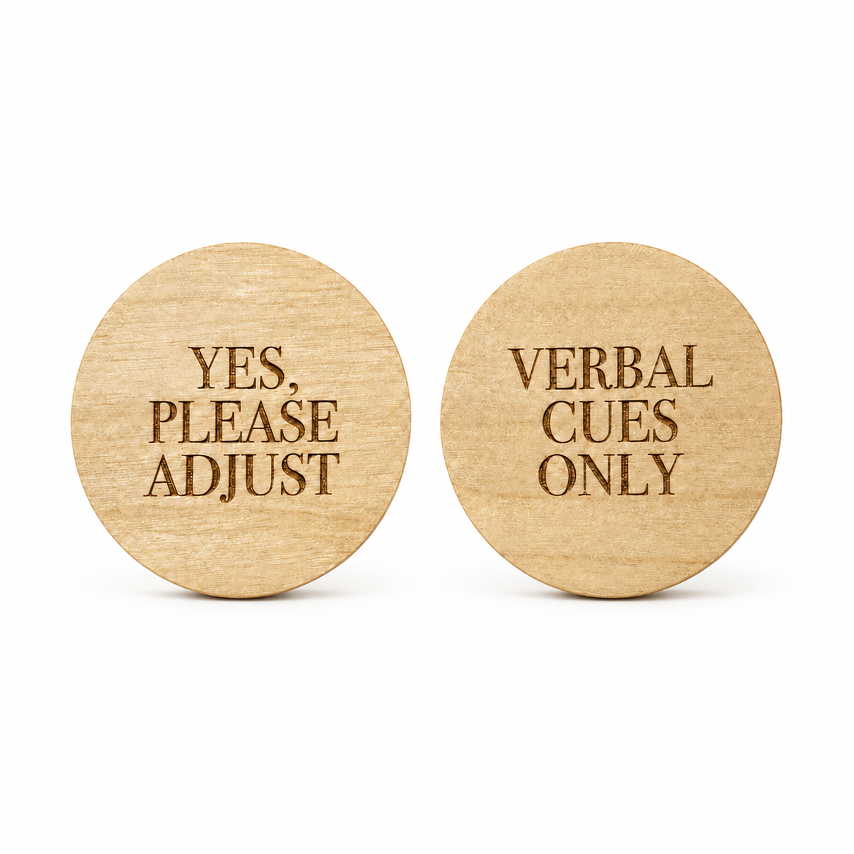 Two round natural wood signs on a white background, one reading 'YES, PLEASE ADJUST' and the other reading 'VERBAL CUES ONLY'.
